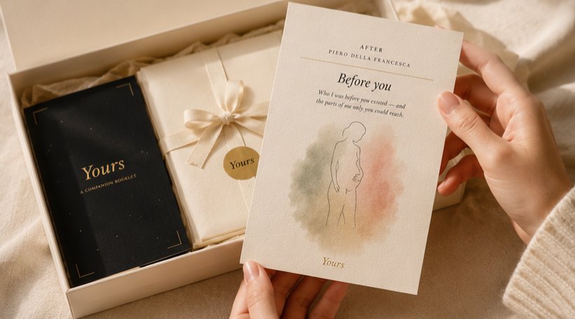 Two hands holding one of the painting cards above the open box, with the companion booklet visible alongside